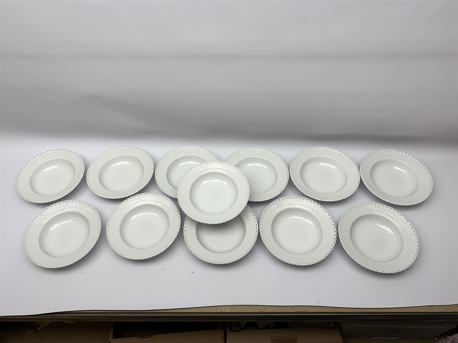 Royal Copenhagen tea and dinner service for twelve place settings, decorated in the Mega Blue Fluted pattern, pattern number 622, comprising dinner plates, salad plates, bowls with pierced rim, smaller bowls, tea cups, and saucers, dinner plates D27.5cm, salad plates D22cm