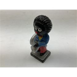 Robinson Jam plaster Golly band, including drummer and singer, H7.5cm

Originally handmade by mothers in Africa for their children from old fabric and cloth, the golly doll was adopted as the mascot and trademark for the Robertson's confectionery brand around 1910 after the company's founder John Robertson visited the US and noticed children playing with them. Robertson's Gollies have been collected by people across the UK and around the world for generations but garnered a contentious image in the 1980s because of links to racism. The trademark was removed from Robertson's branding in 2001.