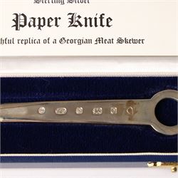 Early 19th century silver caddy spoon, Elizabeth II caddy spoon, various silver condiment spoons, sugar tongs, napkin ring, other silver cutlery and a silver paper knife, boxed