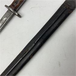 WWI British Pattern 1907 bayonet with 42cm fullered steel blade and two-piece wooden grip; various marks to ricasso including date 12 -?7; in leather and steel mounted scabbard L57cm overall