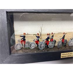 Ten Hinrichsen of Nuremberg flat figures cased French cyclists, with hand painted back drop, paper label to the front marked 'Heinrichson om Hurnburg French Army Cyclists C1914', H10cm, L29cm 