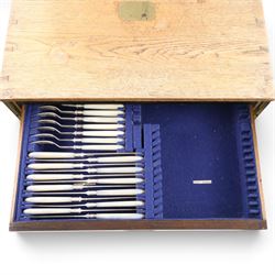 Ealy 20th century oak canteen, with five drawers behind double doors, four drawers containing a part set of silver plated Hanoverian pattern cutlery with engraved monograms and a set of twelve mother of pearl handled fruit knives and forks, the last drawer containing a collection of loose silver plated cutlery, canteen H39cm, W48cm