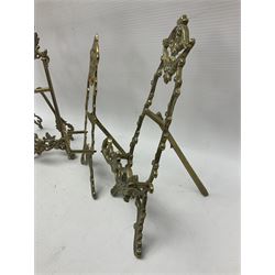 Nine ornate cast brass easel stands of various sizes, H24cm