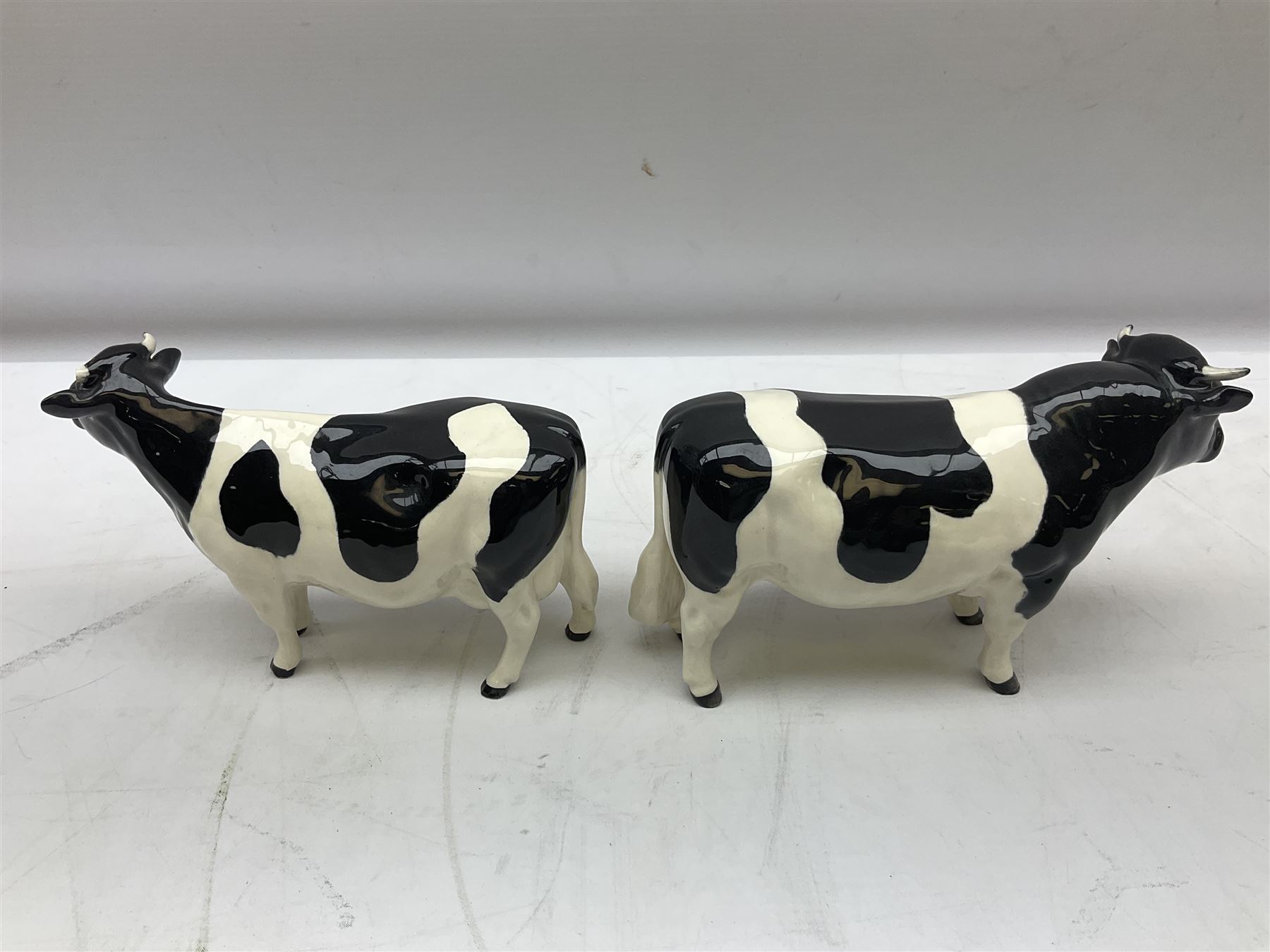 Seven Beswick cow figures, to include Friesian bull Ch. ''Coddington Hilt Bar'' no. 1439a, Friesian cow Ch. 'Claybury Leegwater' no. 1362a and Friesian calf no. 1249C, Aberdeen Angus calf 1827a, Jersey cow no. 1345 etc, all with printed mark beneath  