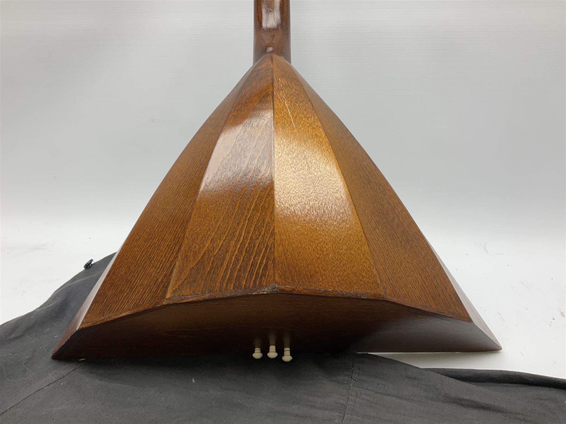 Russian balalaika with six-piece segmented back, the top painted with a scene of Russian onion capped buildings monogrammed K.B.H.1993; bears cyrillic label; L67.5cm; in carrying bag