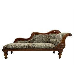 Victorian mahogany framed chaise longue, shaped arm carved with acanthus leaves, the scrolled back with applied carved rosettes,upholstered in monochrome leopard print fabric with bolster cushion, raised on turned supports