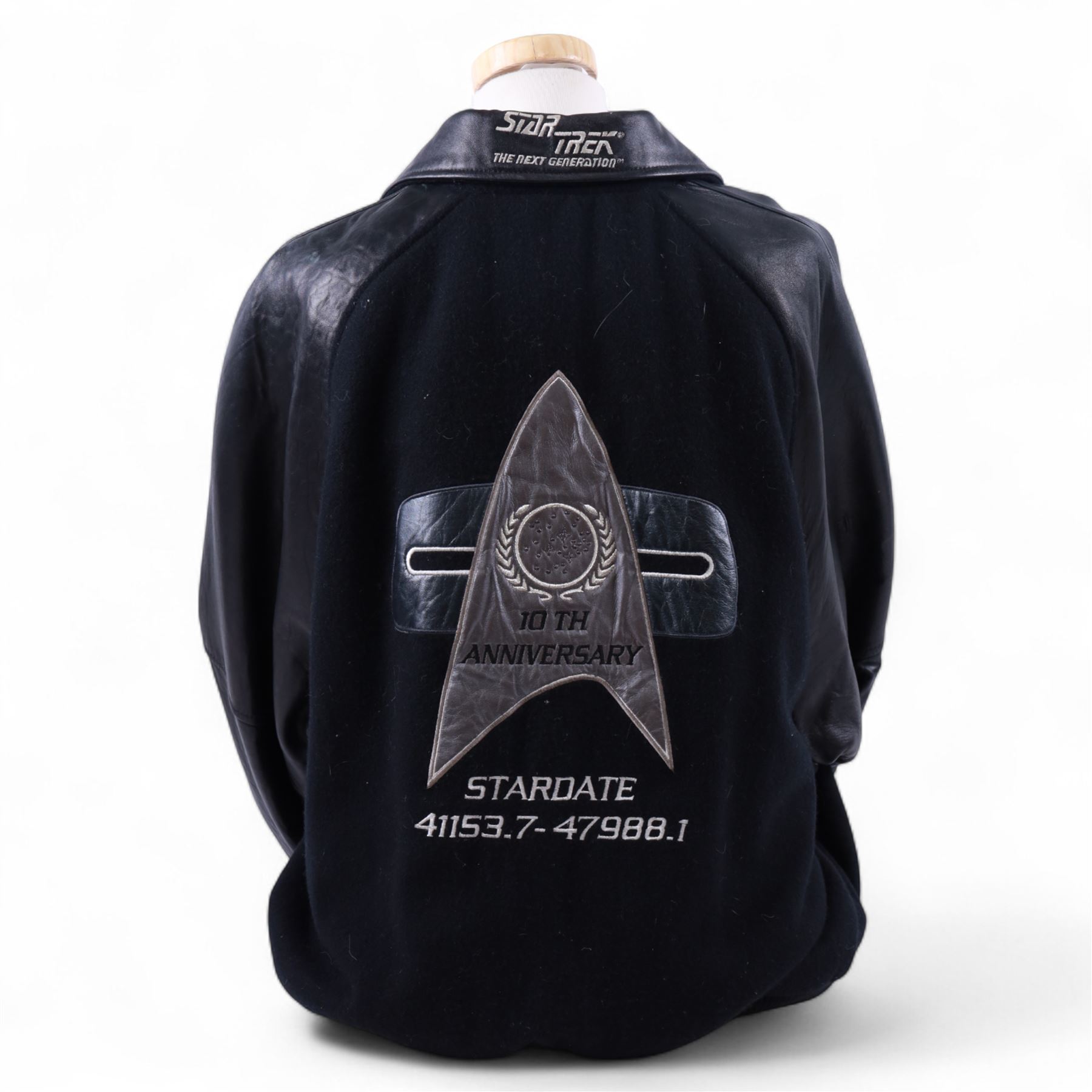 Star Trek The Next Generation 10th anniversary jacket, leather sleeves and collar with embroidered decoration throughout, including 10th anniversary emblem to back, 'Star Trek The Next Generation' to collar, 'Paramount Pictures Stages 8,9 & 16' to front and seven character names to interior, in size XXXXL, purchased in 1990s from Star Trek Experience Las Vegas