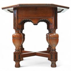 Late Victorian oak centre table, octagonal moulded top over a carved Gothic arched frieze, raised on quadruple baluster turned supports united by X-stretcher with ebonised detailing