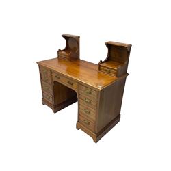 Edwardian walnut kneehole dressing chest, rectangular top with moulded edge and two trinket drawers, fitted with single frieze drawer, flanked by eight graduating drawers with shaped facias
