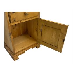 Pine chest of drawers topped with carved pediment with acorn and oak leaf motif, fitted with two short over three long drawers, standing on shaped apron base (W92, D46, H97cm); pine bedside cabinet, single drawer above paneled cupboard door enclosing open storage, shaped plinth base (W43, L32, H67cm)