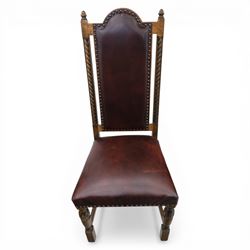 Carolean revival oak dining table and eight chairs (7+1), refectory table with rectangular boarded top and cleated ends, raised on shaped trestle end supports with central stretcher, accompanied by eight high-back chairs including a carver, leather upholstered panels and seats with studwork, on turned legs with stretchers.