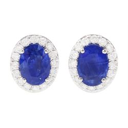 Pair of 18ct white gold oval cut sapphire and round brilliant cut diamond cluster stud earrings, hallmarked, total sapphire weight approx 2.05 carat