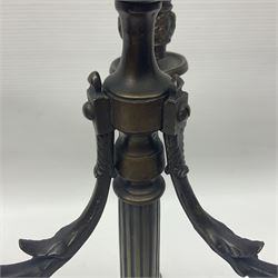 Pair of Grand Tour style bronze candelabra, each with trefoil base supporting three paw feet and base cast with fruiting vines, leading to a fluted column with central nozzle with conforming fruiting vine detail above drip pan, and supporting three curved branches with confirming sockets and drip pans, H34.5cm