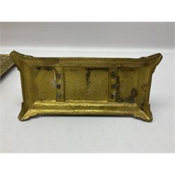 Brass desk stand, ornately embossed with floral and scrolling decoration, containing two inkwells and pen tray, flanked by a griffin to either side, together with a brass letter rack, with pierced green man mask decoration, desk stand H17cm, W30.5cm