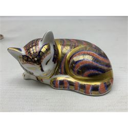 Three Royal Crown Derby Imari pattern paperweights, comprising seated kitten, sleeping kitten and large seated cat, one with gold stopper, all with boxes