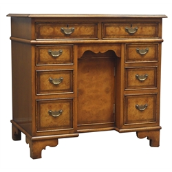  George ll style walnut kneehole desk, rectangular top with leather inset, eight drawers and small frieze drawer, single cupboard, on bracket feet, W81cm, H78cm, D52cm  