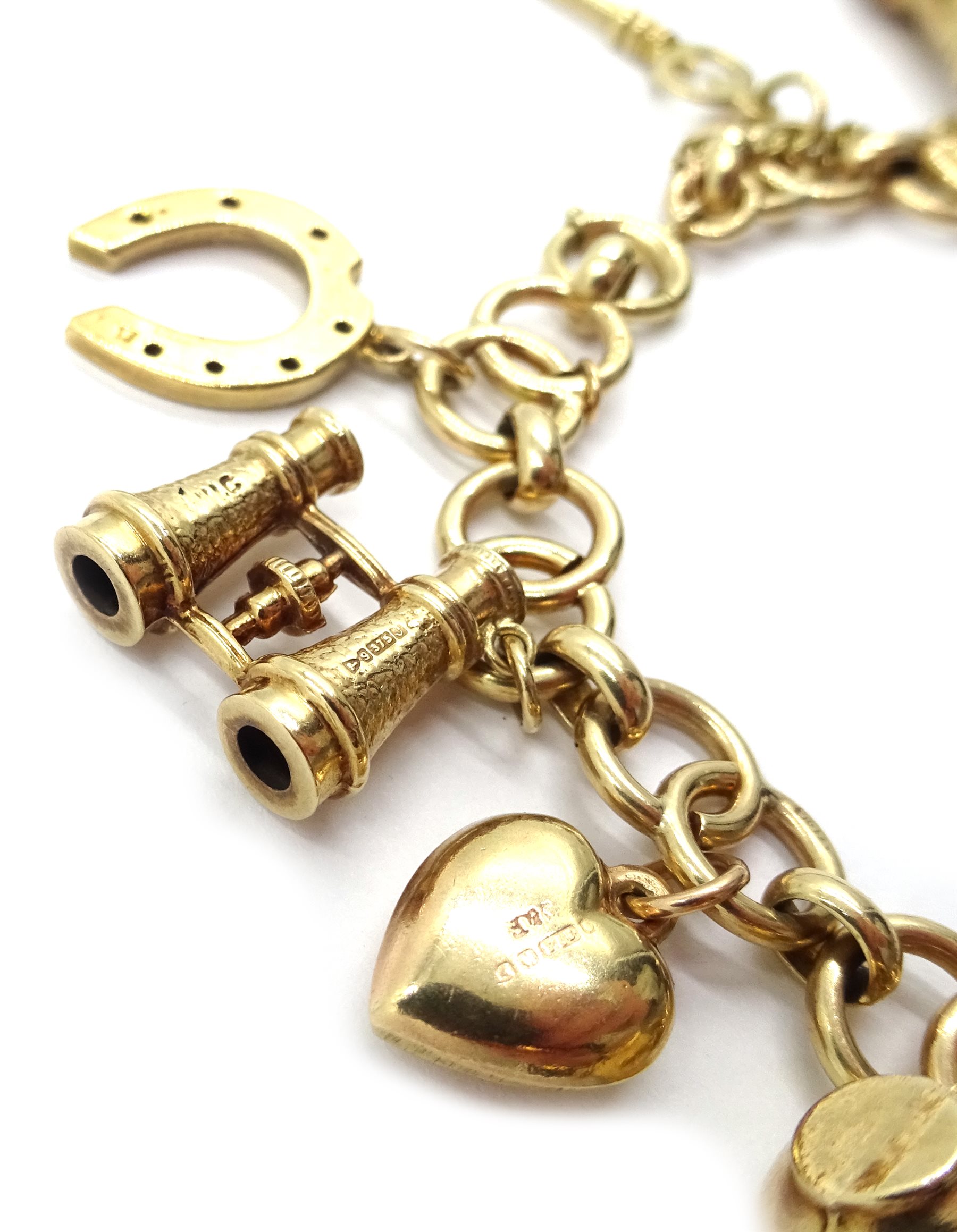 9ct gold bracelet stamped 9.375, with thirteen 9ct gold charms all