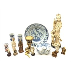 An Oriental blue and white box and cover of ingot form, L15cm, together with an early 19th century blue and white tin glazed plate, D27cm, a pair of blue and white vases, large carved ivorine figure, various other carved ivorine figures, etc. 