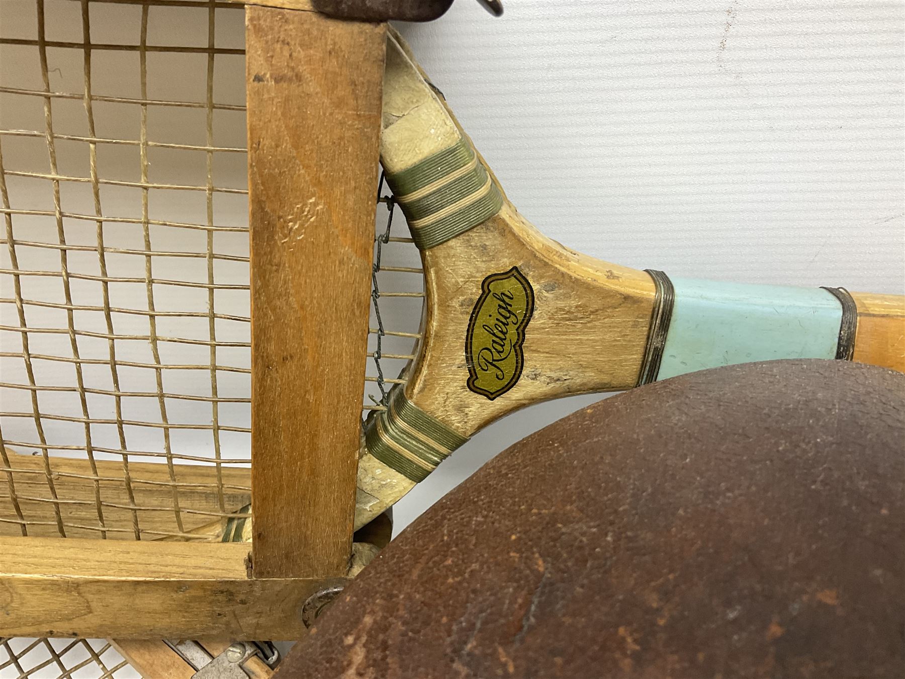 Quantity of early 20th century and later tennis rackets, to include Artus Majesty, Dunlop Alpha, Atlas Silver Shield and Raleigh Konni, together with a stitched rugby ball