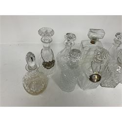 Ten decanters to include an I.W. Harper example of concave square form and two examples with tags, all with stoppers