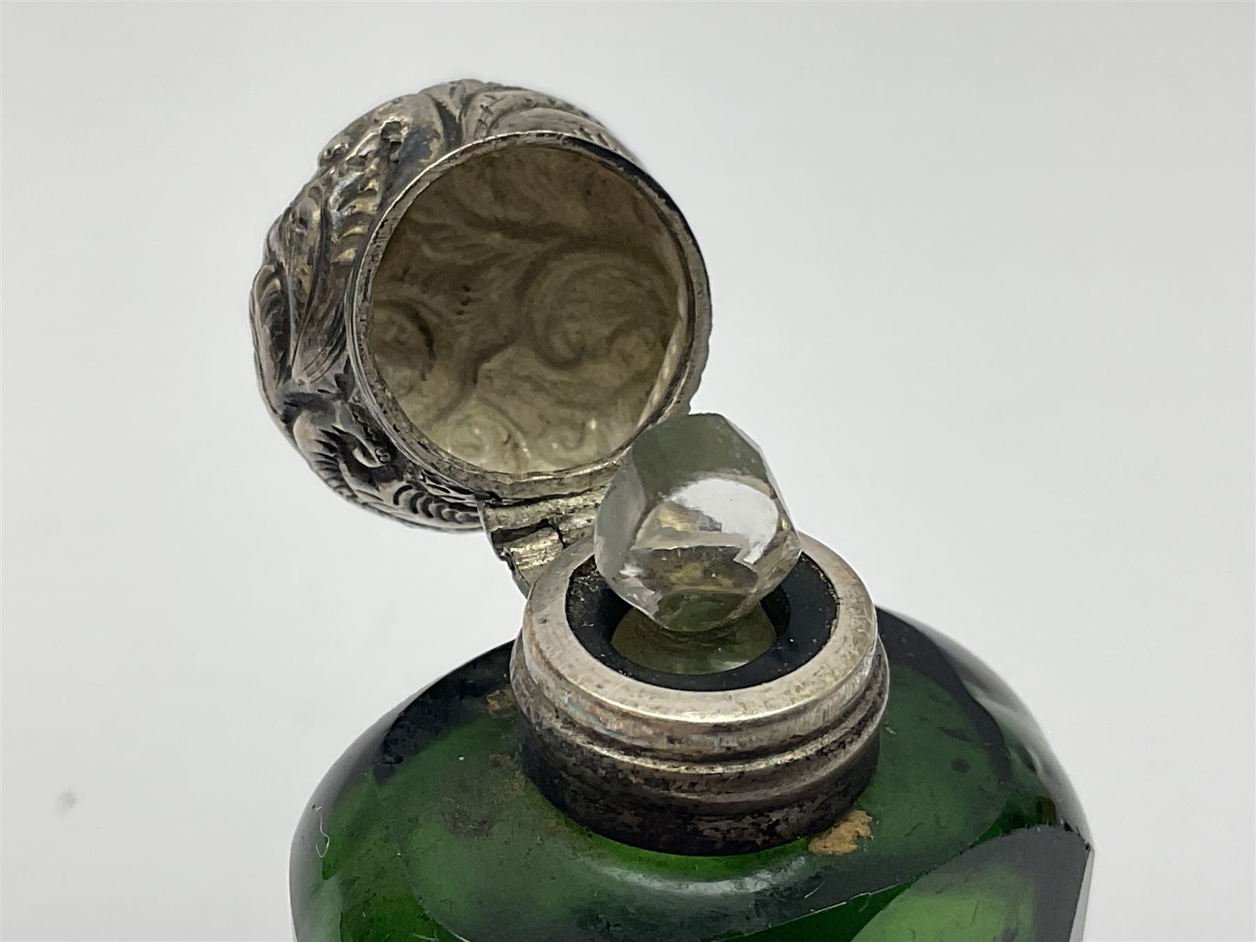 Silver mounted green glass scent bottle, with original stopper, and embossed silver cover, H7cm