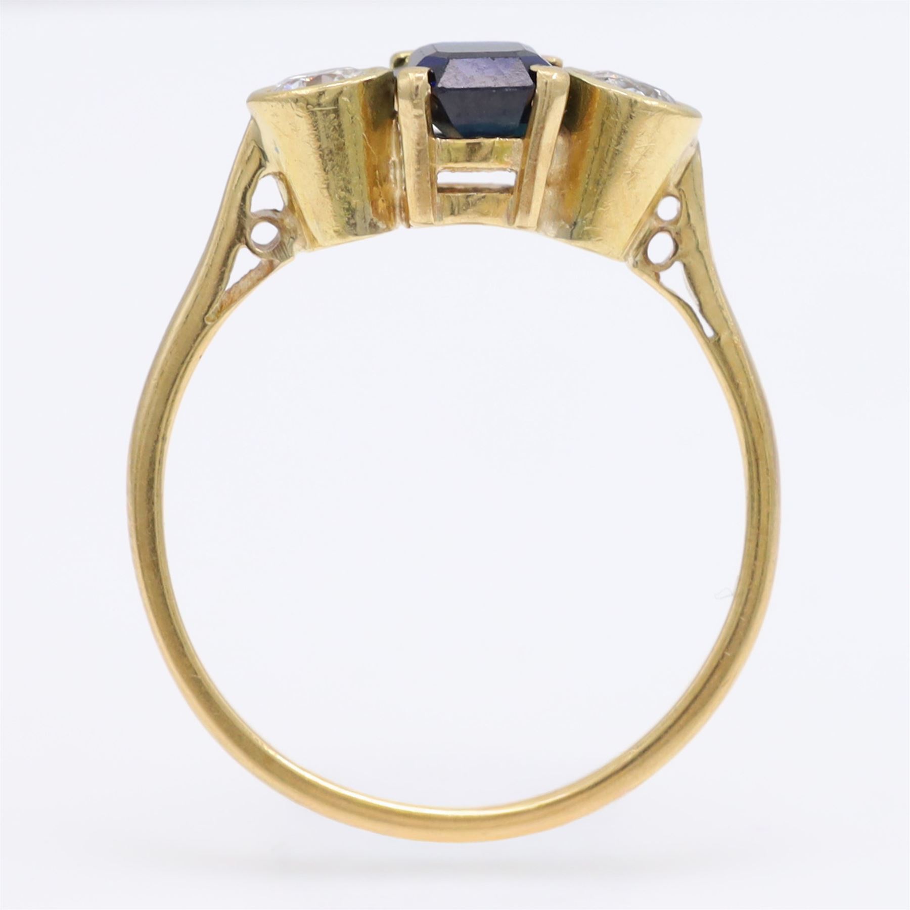 18ct gold sapphire and diamond three stone ring, single octagonal cut sapphire, with a single round brilliant cut diamond set either side, total diamond weight approx 0.25 carat