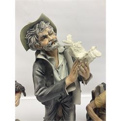 Three Capodimonte figures, to include The Kind Heart Man, modelled by Cortese as a tramp with two doves, The Young Falconer by Maria Angela and another modelled as a tramp darning his socks, all with printed marks, tallest H39cm