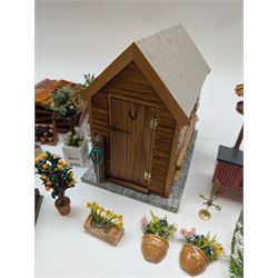 1:12 scale dolls house allotment and garden accessories, including wooden shed on a stone effect base, two vegetable patches, terracotta plant pots with flowers and foliage, stone effect plant pots, other planters, loose sunflowers, scarecrow, rabbit hutch, garden tools, fencing panels, etc 