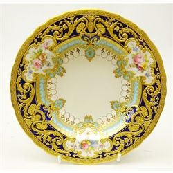 Royal Crown Derby dessert bowl from the Judge Elbert Henry Gary service, circa 1909, hand painted by Albert Gregory with baskets of flowers in cartouche shaped panels on cobalt blue and turquoise ground with raised gilded border incorporating an oval medallion with the initial 'G' by George Darlington, signed A. Gregory and G.W. Darlington, printed back stamp in gilt with Royal Warrant and Tiffany & Co retailer's mark, D21cm. Provenance Property of Bob Heath, Brandesburton Formerly of Ravenfield Hall Farm near Rotherham  