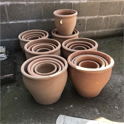 A quantity of approx. twenty four tapering terracotta pots - various sizes