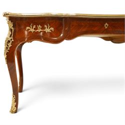 Baggio Anciens Meubles - Italian Louis XV style kingwood and gilt metal mounted bureau plat or writing desk, the shaped rectangular top with inset leather writing surface with gilt metal edge, above three shaped frieze drawers with gilt metal handles, raised on cabriole supports with gilt cartouche mounts to the knees and scroll feet