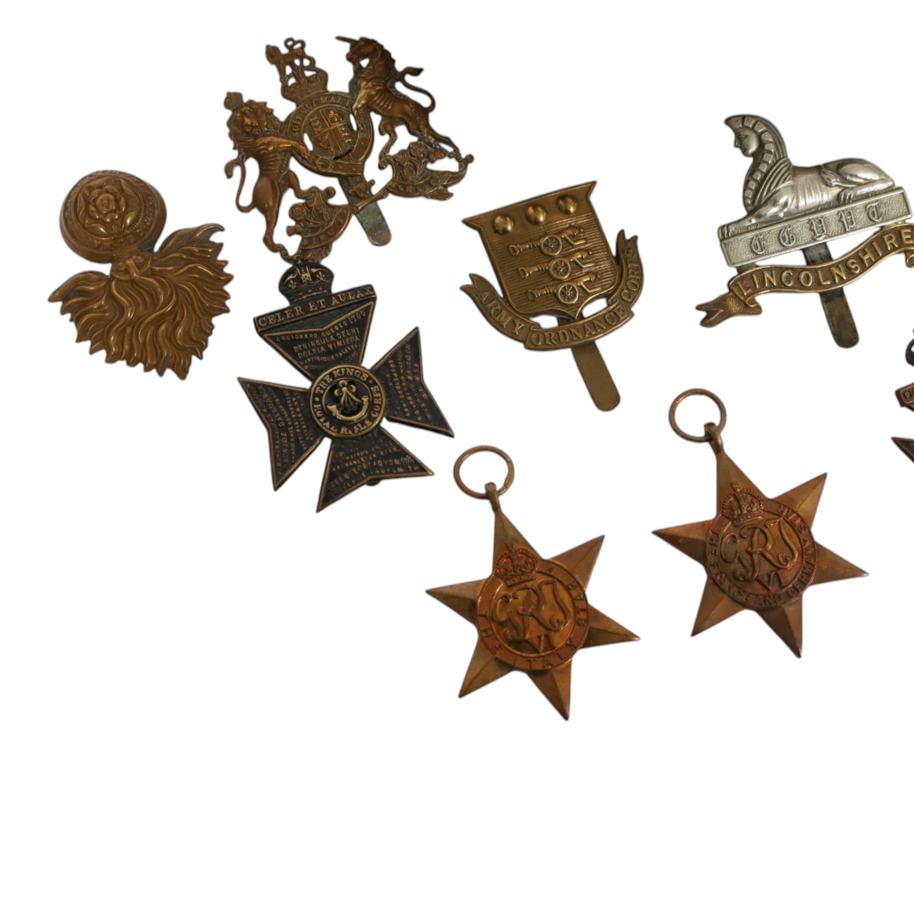 WWII seven British medals, comprising two War medals, two 1939-45 stars, African star, Italy star and French and German star, together with a collection of cap badges including The Kings Royal Rifles, Royal Engineers, East Lancashire, York and Lancaster regiment museum etc  