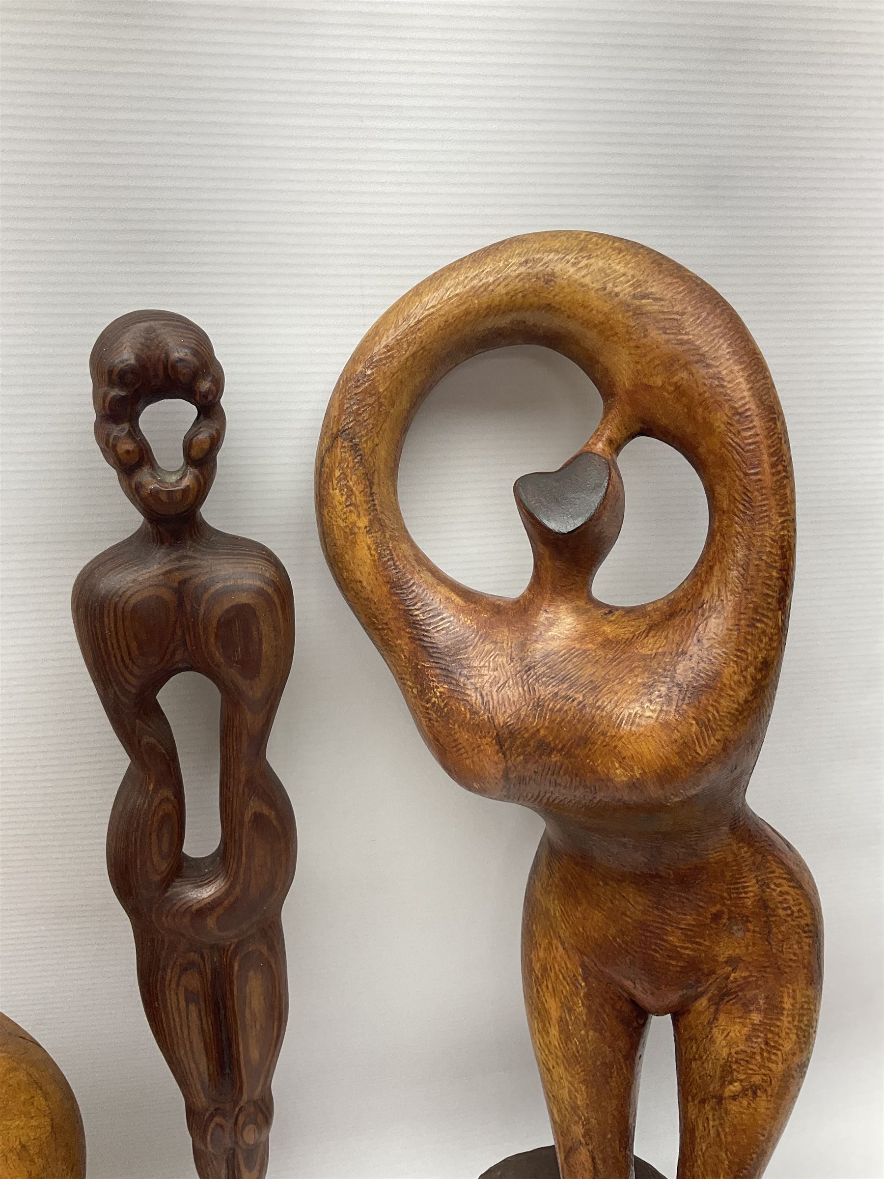 Helen Skelton (British 1933 – 2023): Three carved wooden abstract sculptures, each modelled as a a figure, tallest H52cm. Born into an RAF family in 1933 in Kent and travelled the world extensively during her childhood. After settling in Bridlington, Helen immersed herself in painting, textiles, and wood sculpture, often inspired by nature's beauty. Her talent was showcased in a one-woman show at Sewerby Hall and recognised with the sculpture prize at Ferens Art Gallery in 2000. Sadly, Helen’s daughter passed away from cancer in 2005. This loss inspired Helen to donate her sculptures to Marie Curie upon her passing in 2023.