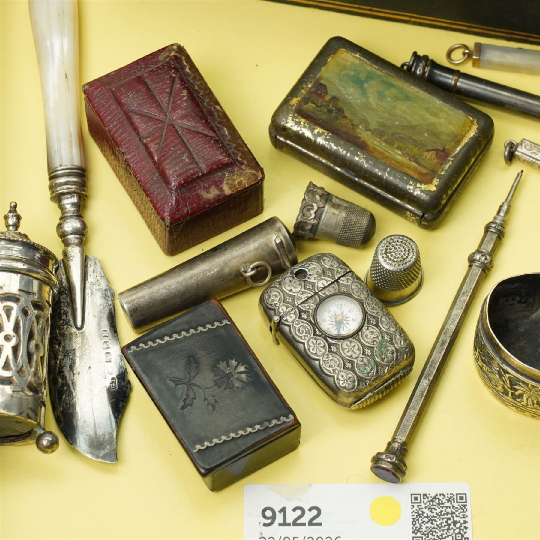 Silver bladed and mother of pearl butter knife, silver vesta case, 19th century papier mache snuff box, sterling silver folding glove button hook, silver cheroot holder, napkin ring, plated combination vesta and compass, other small items and a leather jewellery box