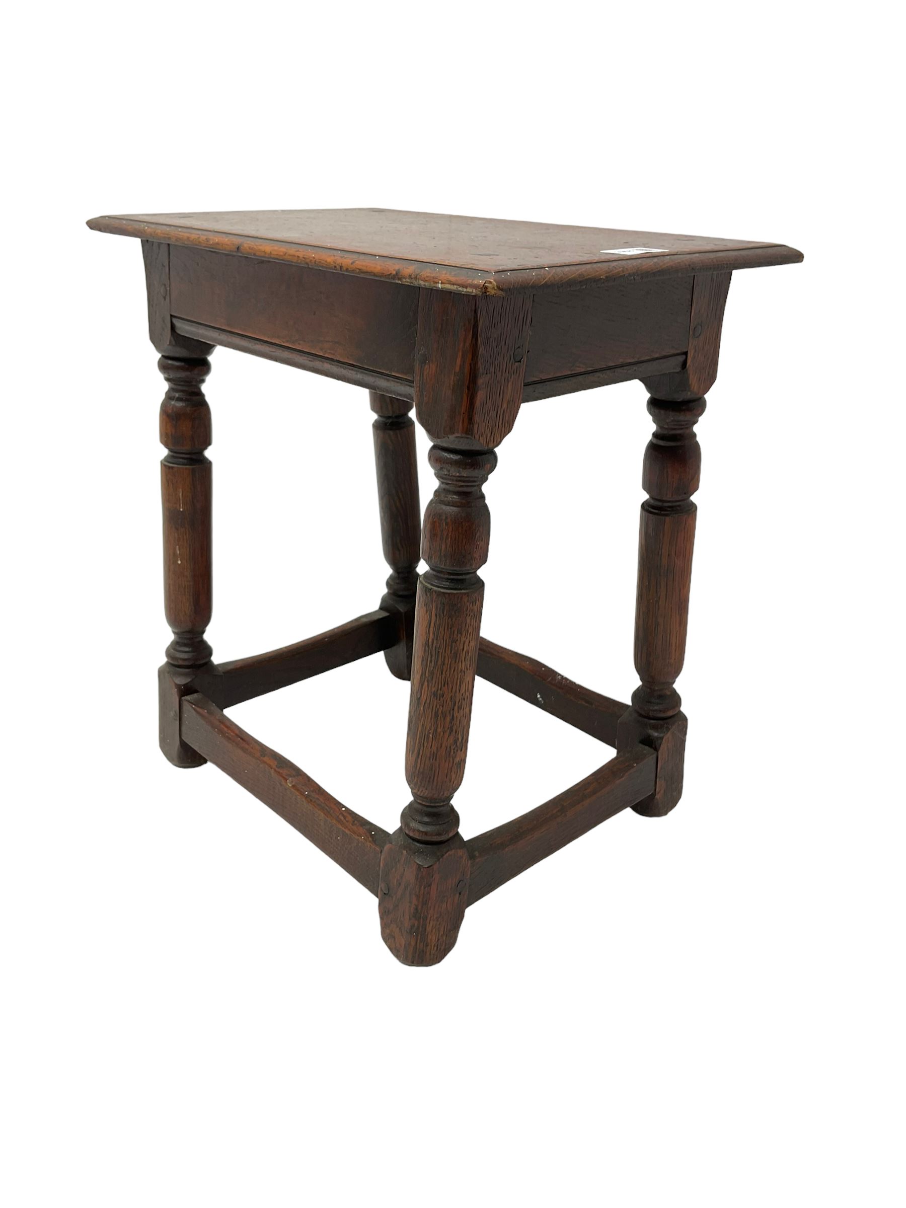 Oak coffin or joint stool, rectangular top with shaped edge over splayed turned supports with stretcher base 