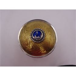 Modern silver limited edition Christmas music box, of circular form, with engine turned parcel gilt wave decoration and applied enamel roundel depicting Bethlehem, the North Star and a crescent moon to centre of hinged cover, upon three parcel gilt feet, with musical mechanism playing Silent Night, no. 94/500, H6.5cm