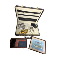 Brass trinket boxes with applied copper decoration, print of a spitfire, black and white postcards and a collection of coins, all housed in a briefcase
