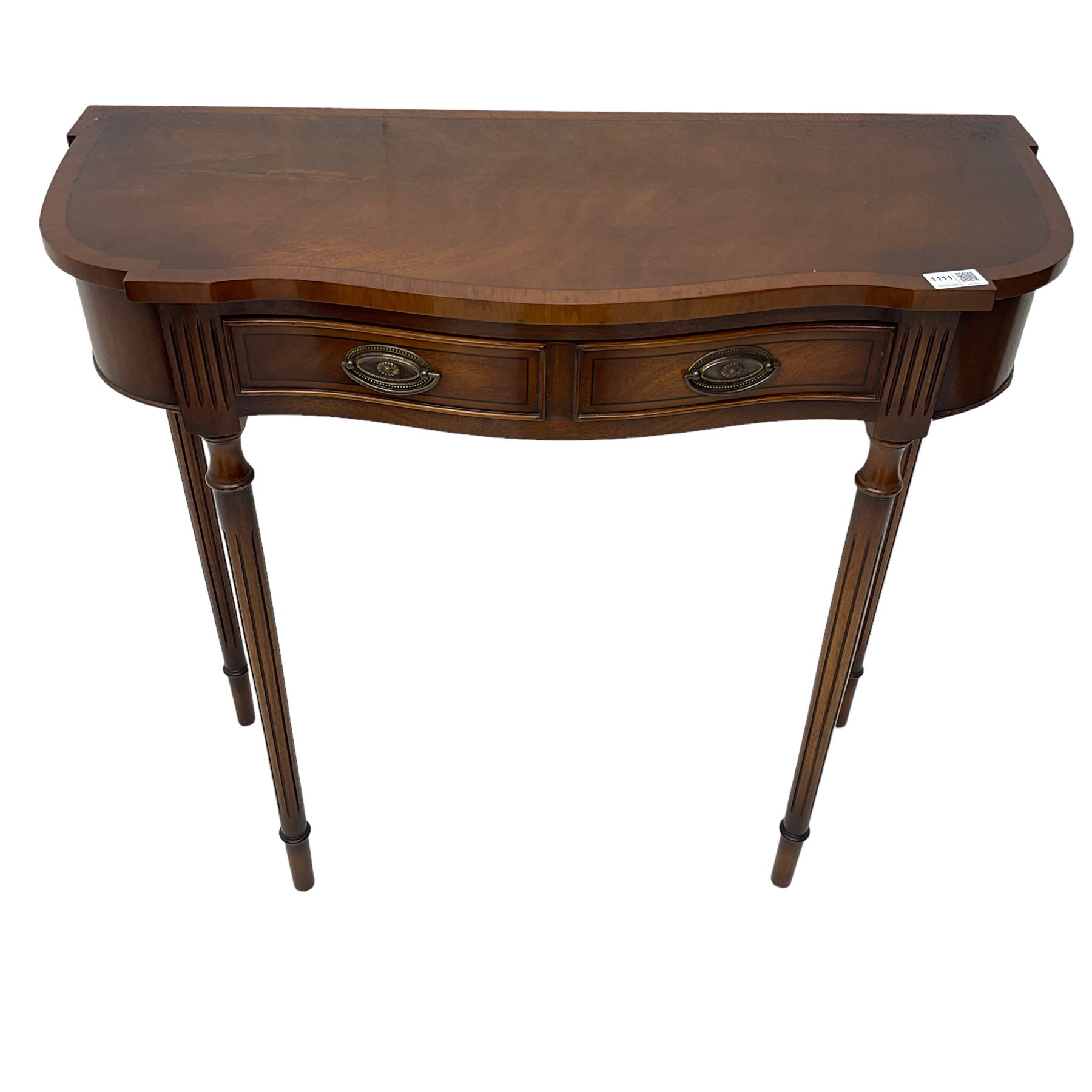 Regency design mahogany serpentine console table, fitted with single drawer disguised as two with cockbeaded facia, raised on fluted tapering supports