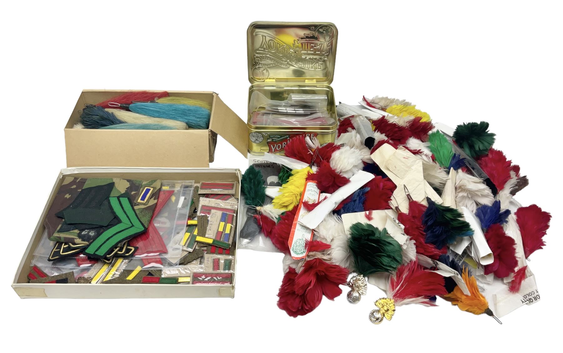Quantity of military horse hair plumes and feather hackles, cloth stripes and regimental titles etc