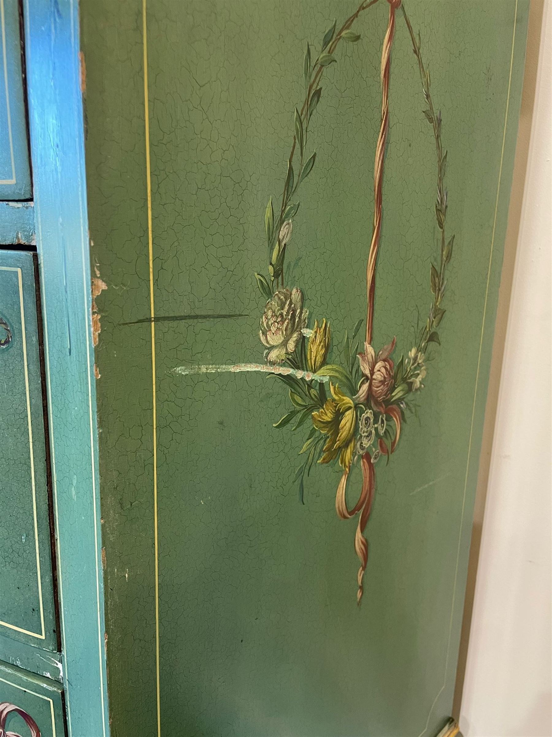 Edwardian Adam Revival green-painted and parcel gilt bowfront chest, moulded and foliate carved top painted with trailing floral band, fitted with four drawers decorated with trailing floral festoons, ribbon ties and urns, oval handle plates with engraved decoration and bead cast handles, on turned supports decorated with acanthus leaves and draped festoons 