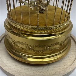 Swiss Reuge Music bird cage automaton music box, the bird with articulated head and beak, in a gilt brass cage, with a glass dome and stand, H30cm