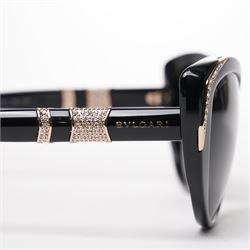 Bulgari - pair of oversized cat-eye sunglasses, with gradient tinted lenses in a black frame, the temples and arms with gold-tone hardware inset with pave-jewelled hinge detail, with original cloth pouch, hard leather case and box