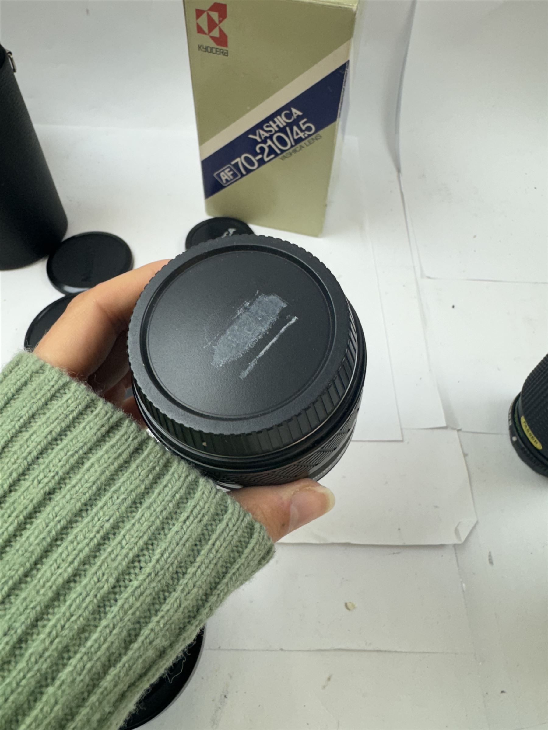 Group of camera lenses, comprising Yashica AF 70-210mm 1:4.5 58mm lens serial no. F6106983, boxed, Yashica AF 35-70mm 1:3.3-4.5 52mm Macro lens serial no. F60231147, Yashikor Aux Wide Angle 1:4 lens and a Yashikor Aux Tele-Photo 1:4 lens, Mamiya-Sekor E 1:2.8 f=28mm serial no. 13427 and a Mamiya-Sekor Zoom E 1:4 f=80-200mm lens serial no. 11271