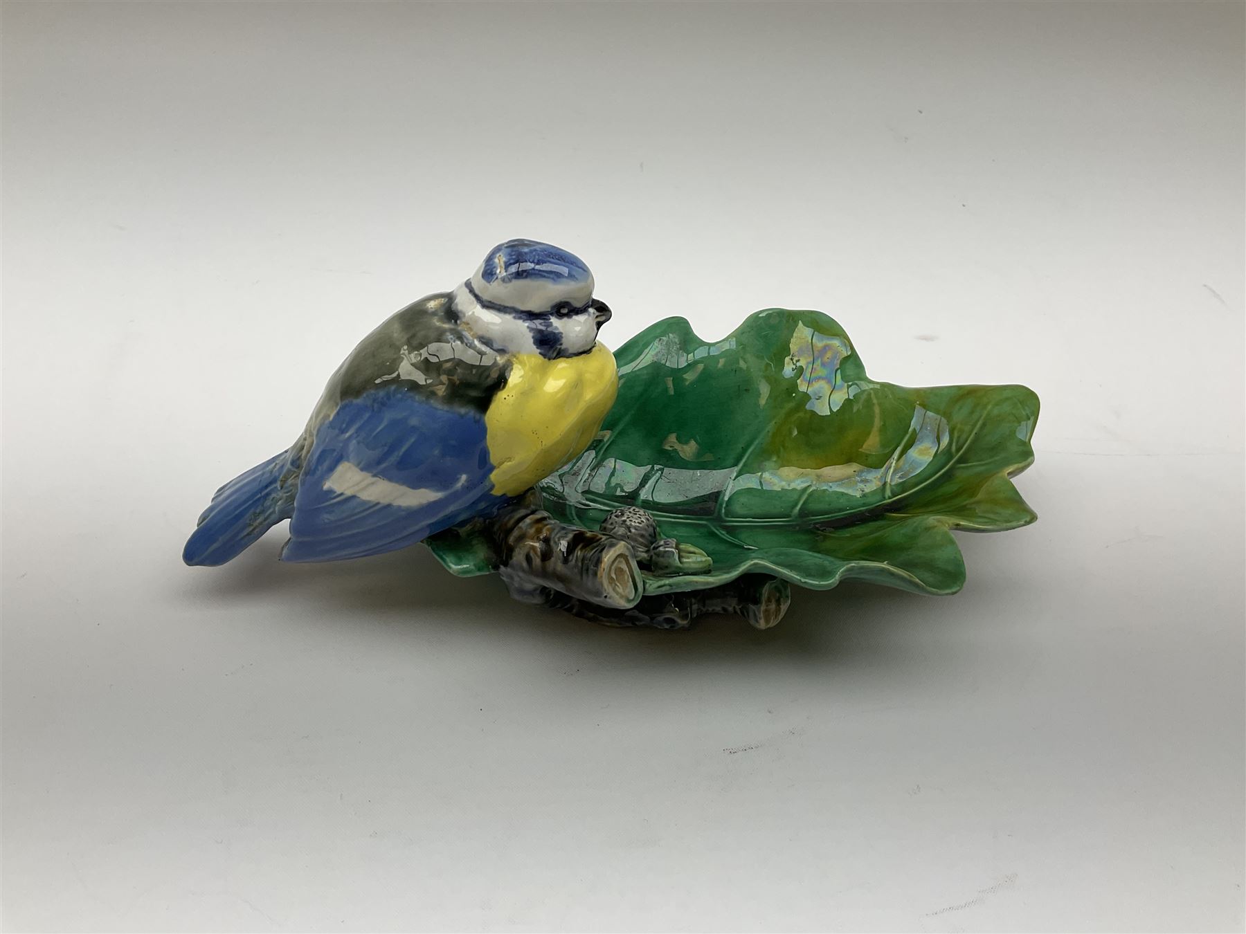 Minton majolica leaf dish, modelled as a Blue Tit perched on a branch with acorns and an oak leaf, date cypher for 1868, impressed marks beneath, L21cm. 