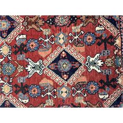 Pair of rugs one Persian hamadan rug central stepped medallion enclosing geometric motifs in ivory and brown, framed by a cream border with scrolling palmettes and fringed ends (H 156cm W 105cm), one Pakistani Bokhara rug rust red ground with repeated Tekke gul motifs within rosette and lozenged borders, fringed ends (H 98cm, W 65cm)