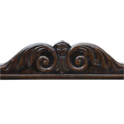 Late 20th century stained beech Savonarola chair, the carved crest rail and open arms above an upholstered leather seat, raised on an X framed base with carved foliate and mask decoration, joined by turned stretcher and ending in castors