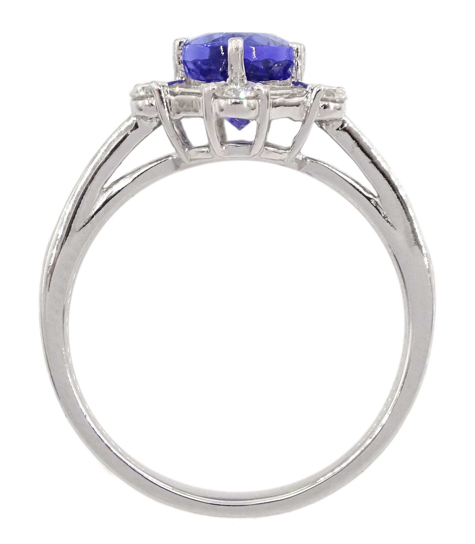 18ct white gold tanzanite and diamond cluster ring, oval tanzanite, with baguette and round brilliant cut diamond surround and baguette cut diamond shoulders, stamped 750, tanzanite approx 1.80 carat, total diamond weight approx 0.55 carat