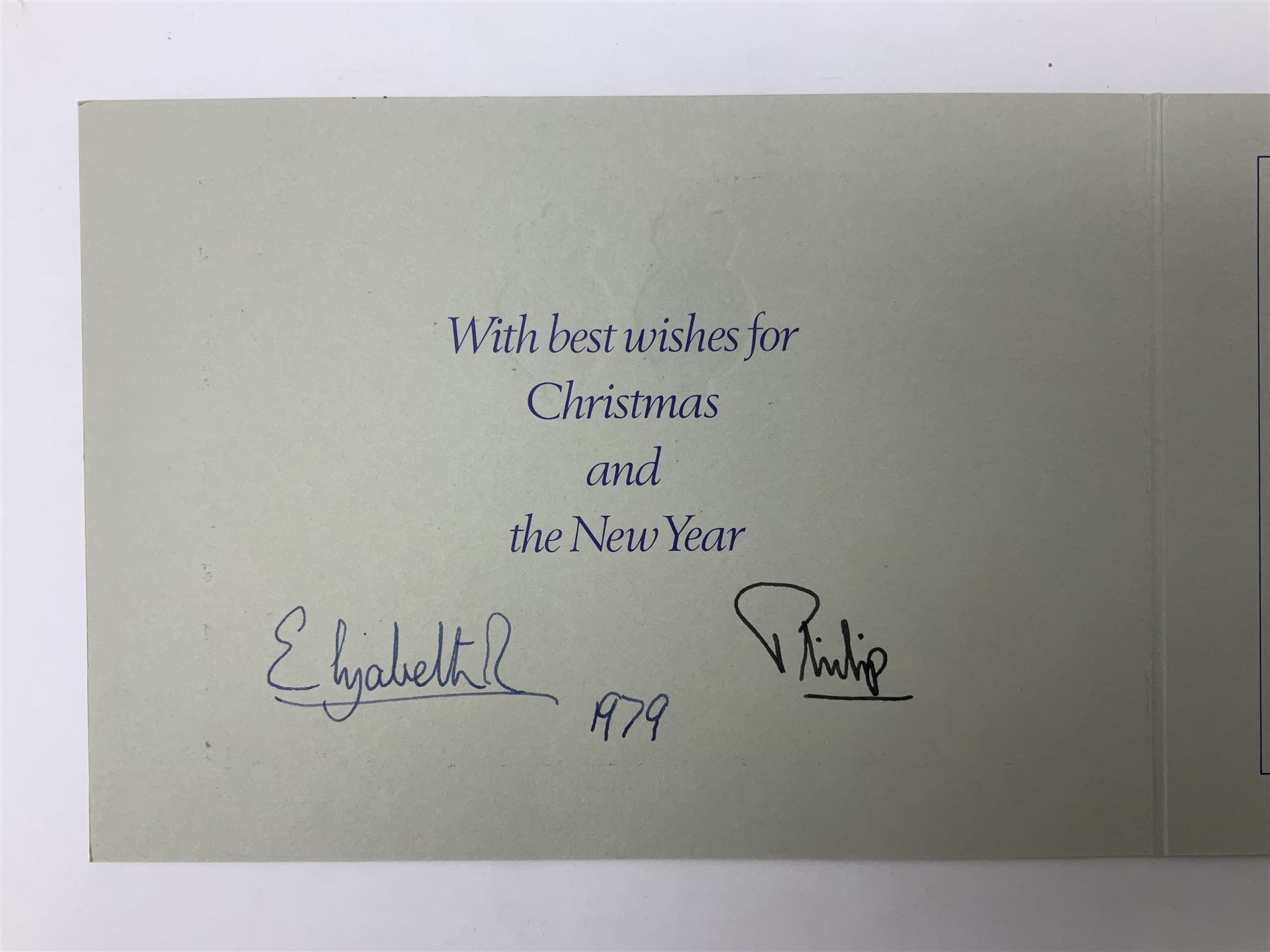 H.M. Queen Elizabeth II and HRH The Duke of Edinburgh, signed 1979 Christmas card with twin gilt ciphers to cover, colour photographic print of the Royal family standing in a garden, signed ‘Elizabeth R and Philip’ with manuscript date 1979 below