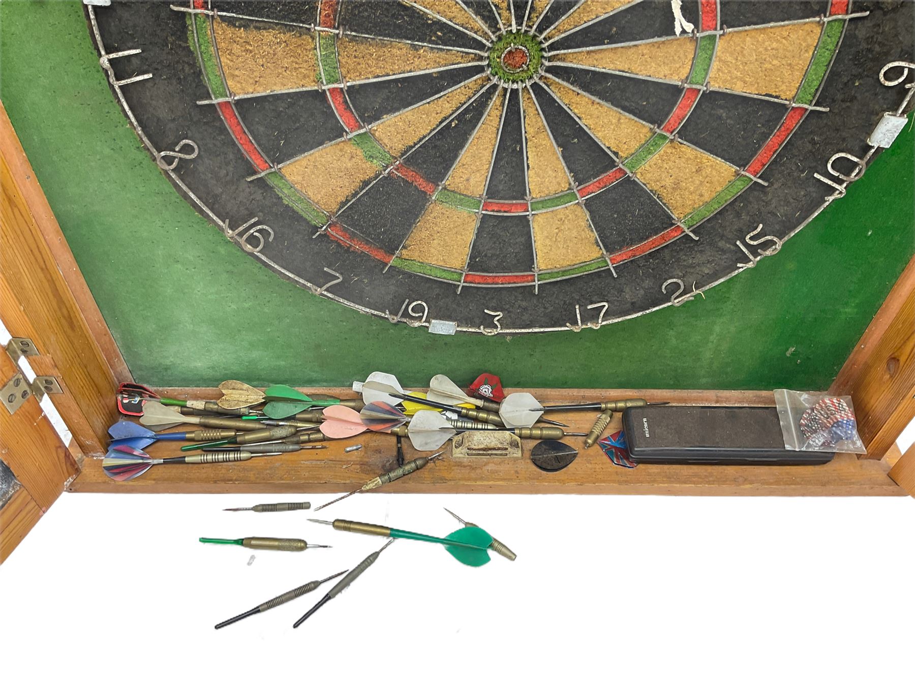 Dart board in wooden cabinet