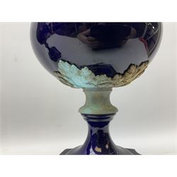 Pair of French large cobalt blue lidded urns, probably 19th century, the body decorated with ormolu ram's heads and ornate foliate design, the domed cover with brass berry finial, raised upon pedestal base with beaded decoration upon shaped plinth, H52cm